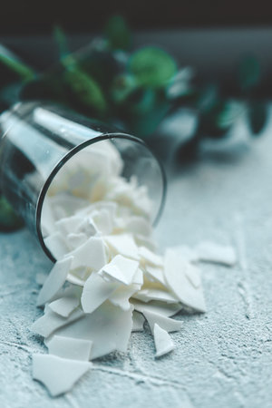 Soy wax is spilled from the glass, space for text.