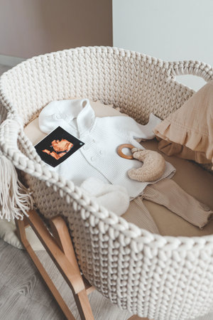 Outfit for a newborn in a baby cradle, concept in anticipation.