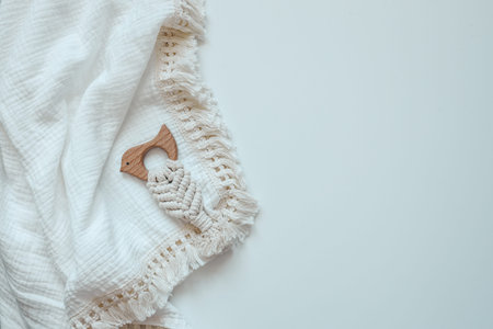 Baby muslin blanket and holder top view on white background.