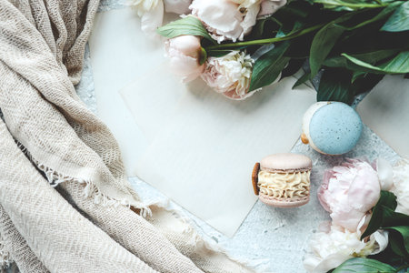 Greeting card with place for your text, white peonies and macarons top view.の写真素材