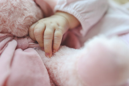 The child sleeps in an embrace with a plush toy.の写真素材