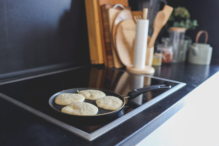 Cooking breakfast, pancakes in a pan.