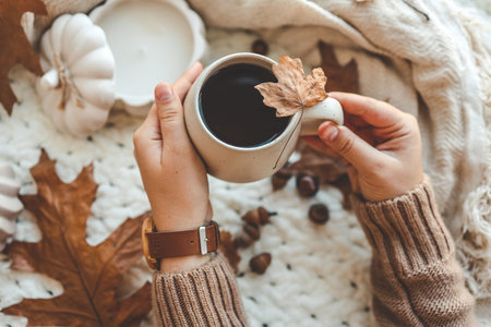 Hands with a cup of tea, good morning concept. Autumn mood.
