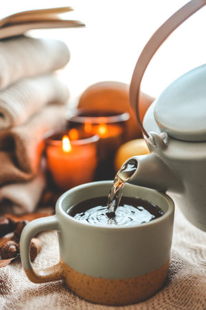Teapot and cup with sea buckthorn tea, autumn mood.の写真素材