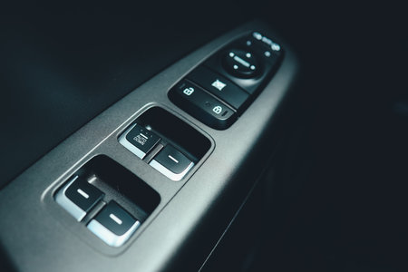 Interior of modern car. Side door buttons: window, mirror adjustment buttons, door lock. Car inside.の写真素材