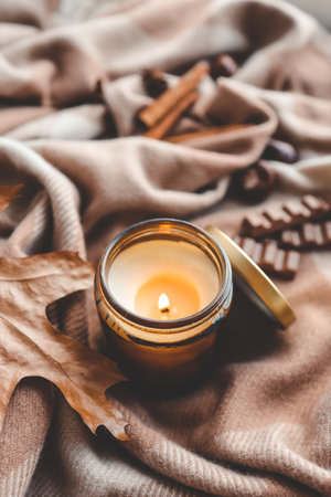 Candle with the scent of cinnamon and chocolate, cozy autumn.の写真素材