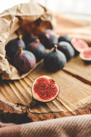 A few figs in a bowl on an old wooden background.