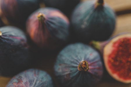 fresh ripe figs on dark background, top view