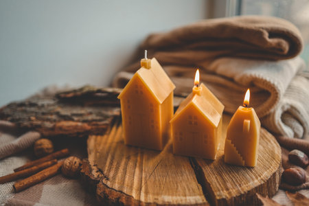 Handmade candles in the shape of a house in an autumn interior.の写真素材