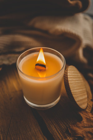 Burning candle in home interior, autumn aesthetics.の写真素材