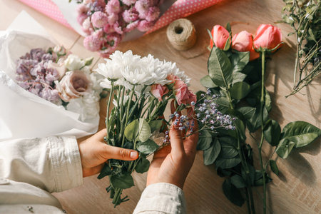 Florist at work. Woman making autumn floral decorations.の写真素材