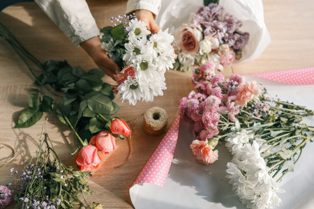 Florist at work. Woman making autumn floral decorations.