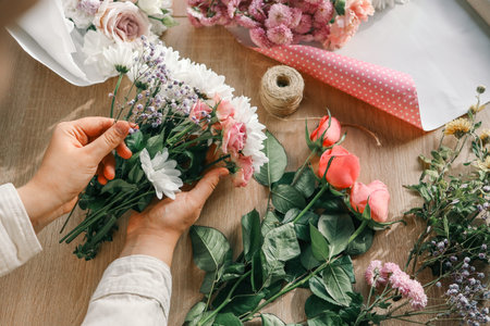 Florist at work. Woman making autumn floral decorations.