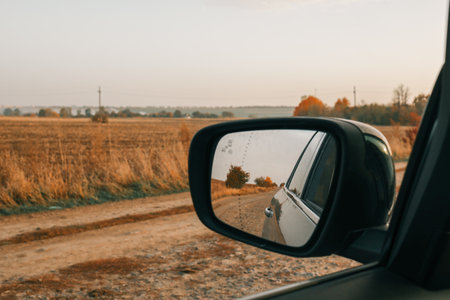 Autumn view from the side mirror of a car.の写真素材