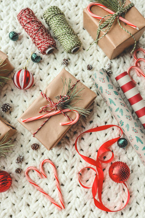Christmas gifts and wrapping paper top view.