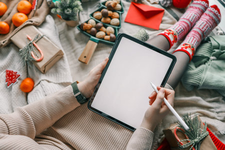 Girl working on a graphics tablet with isolated screen in a Christmas atmosphere.の写真素材