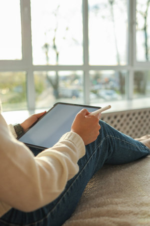 Girl working on a graphics tablet in her home office.