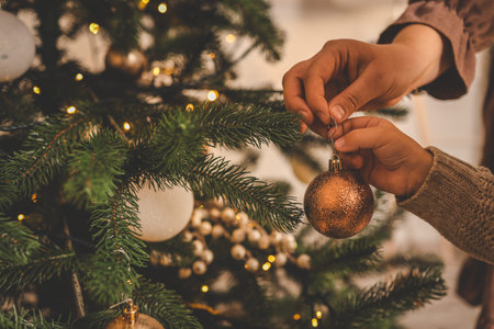 Mom and child decorate the Christmas tree.