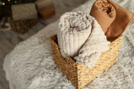 Wicker basket with cozy blankets, home mood.