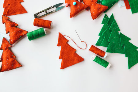 Process of hand made soft toys sewing with felt and needle for Christmas tree decoration.の写真素材