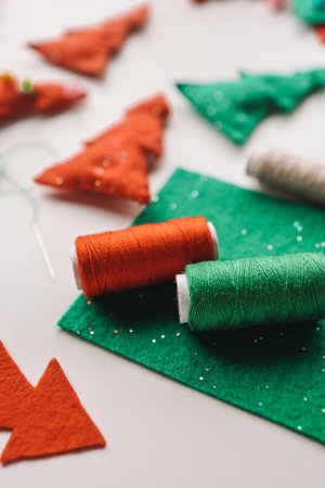 Process of hand made soft toys sewing with felt and needle for Christmas tree decoration.