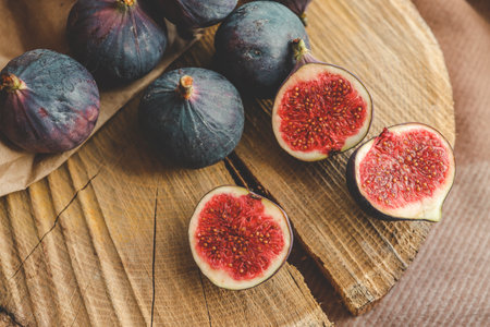 A few figs in a bowl on an old wooden background.の写真素材