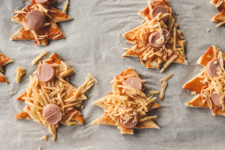 Child making pizza in the shape of a Christmas tree, activity idea.の写真素材