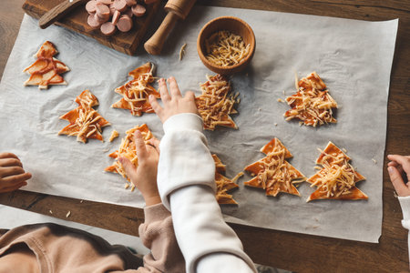 Child making pizza in the shape of a Christmas tree, activity idea.の写真素材