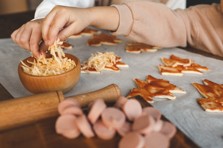 Child making pizza in the shape of a Christmas tree, activity idea.の写真素材