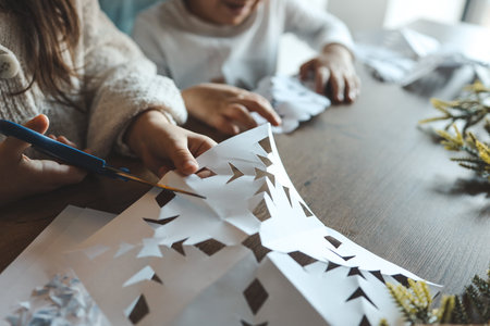 Children cut out snowflakes, Christmas activity.の写真素材
