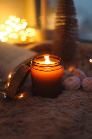 Burning candle in a festive cozy atmosphere.の写真素材