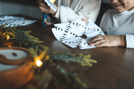 Children cut out snowflakes, Christmas activity.の写真素材