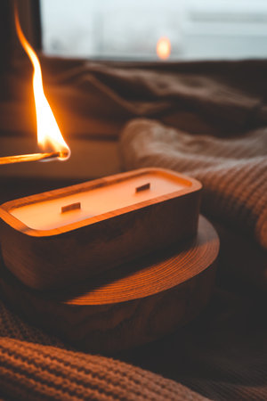 A match lights a candle in wood.の写真素材