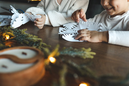 Children cut out snowflakes, Christmas activity.の写真素材