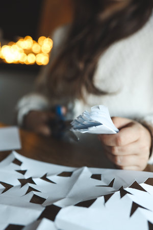 Children cut out snowflakes, Christmas activity.の写真素材