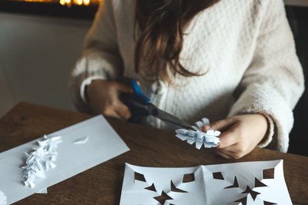 Children cut out snowflakes, Christmas activity.の写真素材