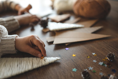 Children making Christmas decorations from yarn.の写真素材