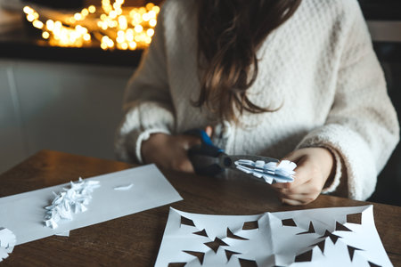 Children cut out snowflakes, Christmas activity.の写真素材