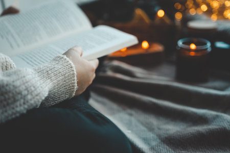 Girl with a book in her hands in a cozy home atmosphere.