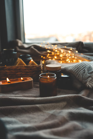 Burning candles in a festive cozy interior.