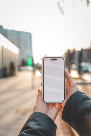 Mobile App Advertisement. The girl is holding a smartphone with a blank screen in her hand. Place...