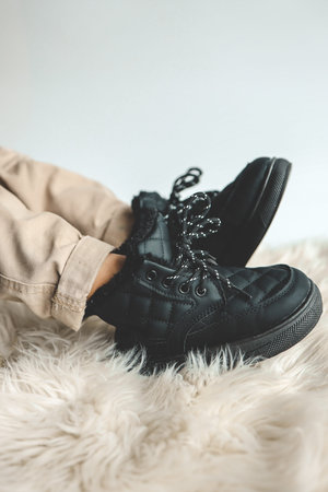 Stylish fashionable black children's shoes, close-up.