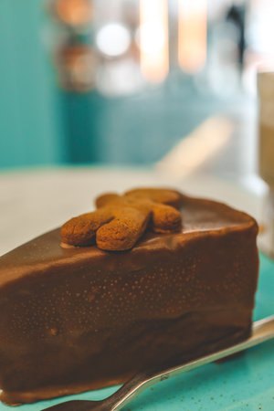 Chocolate cake and a cup of latte in a cozy coffee shop.の写真素材