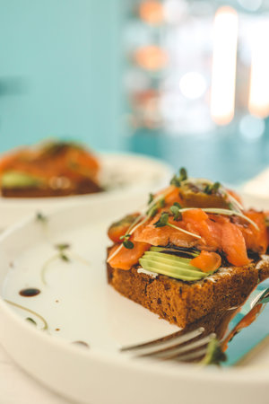 Healthy breakfast. Avocado toasts with poached eggs on ceramic plate.