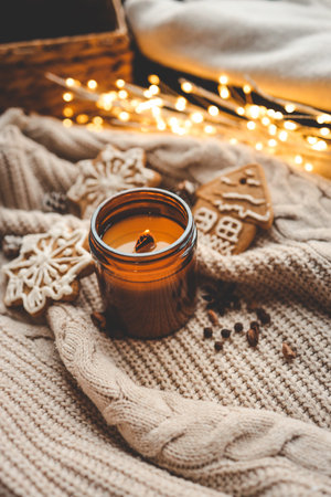 Burning candle and gingerbread, background.