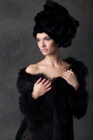 elegant young woman in a black dress with hatの写真素材