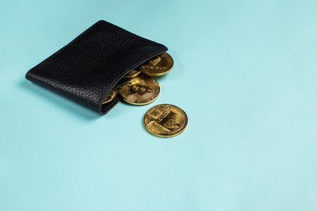 Crypto-currency in the physical purse. The concept of virtual money in the wallet. On a blue background.の写真素材