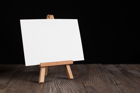 A small easel, a layout, a blank, white on a black background.の写真素材