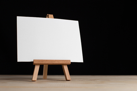 A small easel, a layout, a blank, white on a black background.の写真素材
