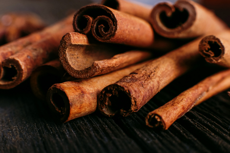Spices sticks cinnamon on old table. Rustic background, aroma close-up.の写真素材